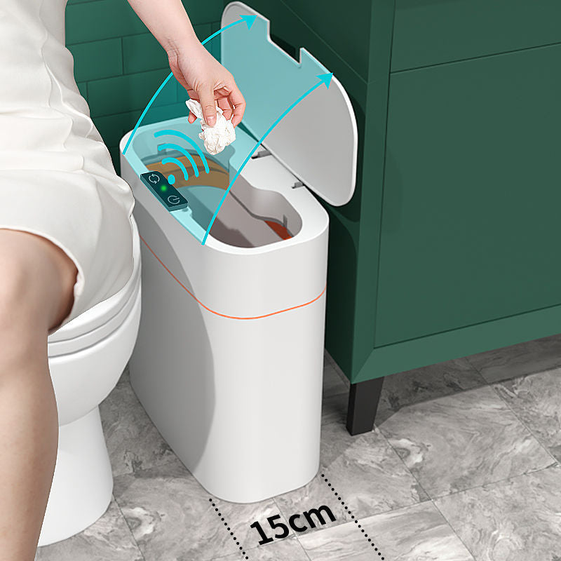 Person using a smart trash can with a digital display in a bathroom setting.