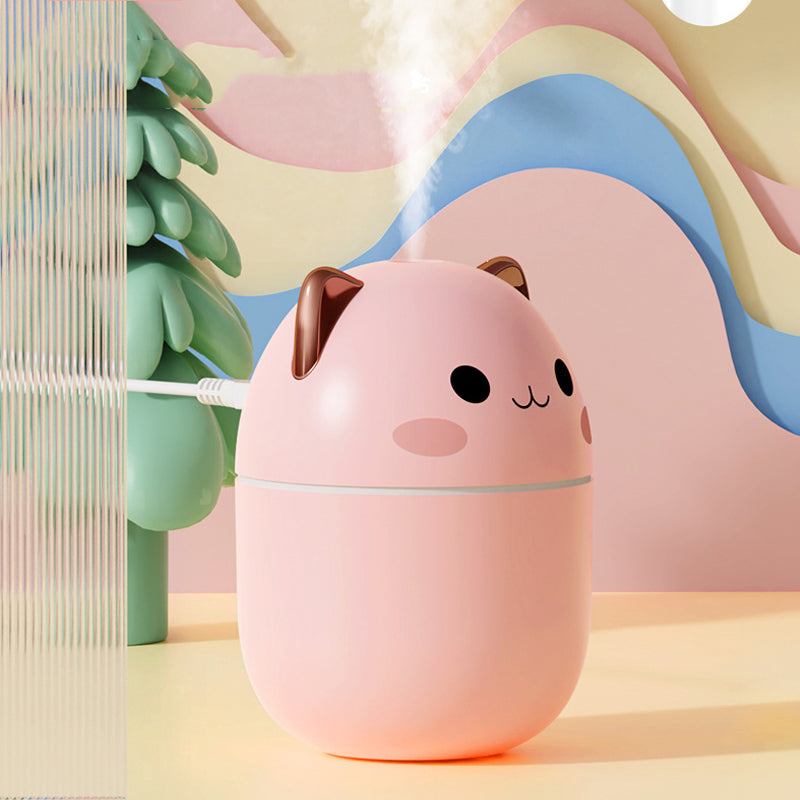 Pink cat-shaped humidifier on a colorful abstract background