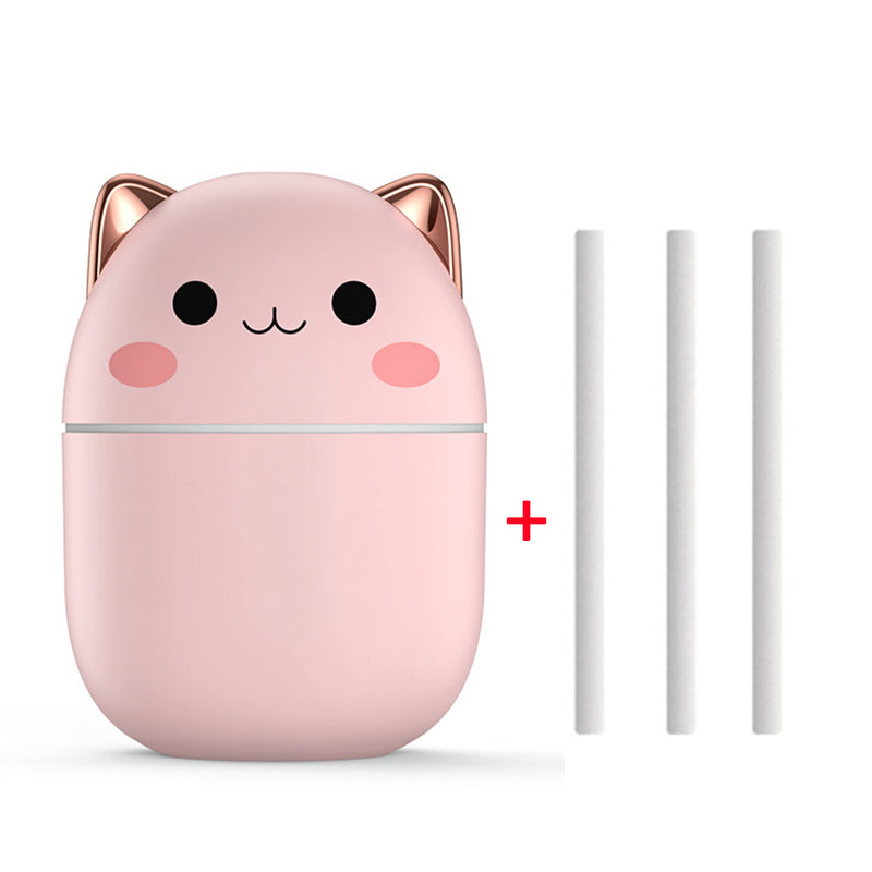 Pink cat-shaped humidifier with two white tubes on a white background
