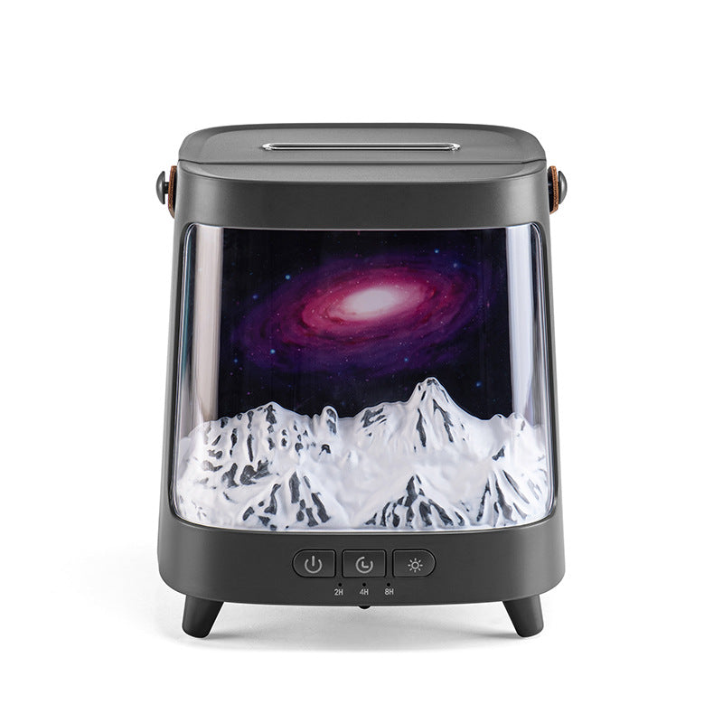 Tabletop device with a galaxy and mountain display on a white background